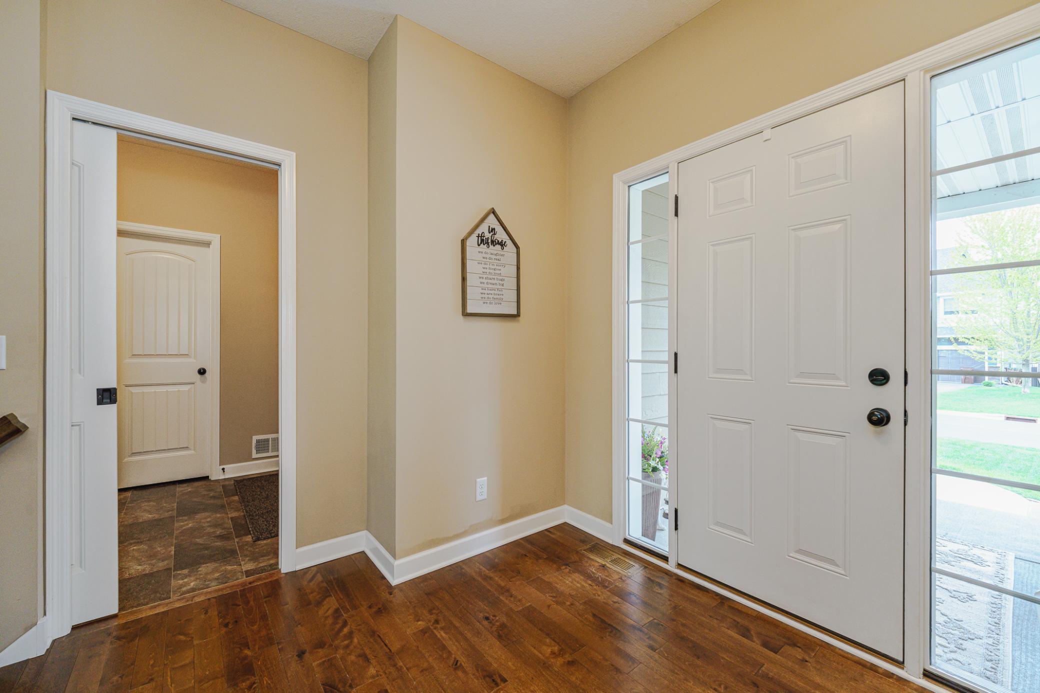 The mud room is accessible via a white pocket door connecting to the foyer and the garage.