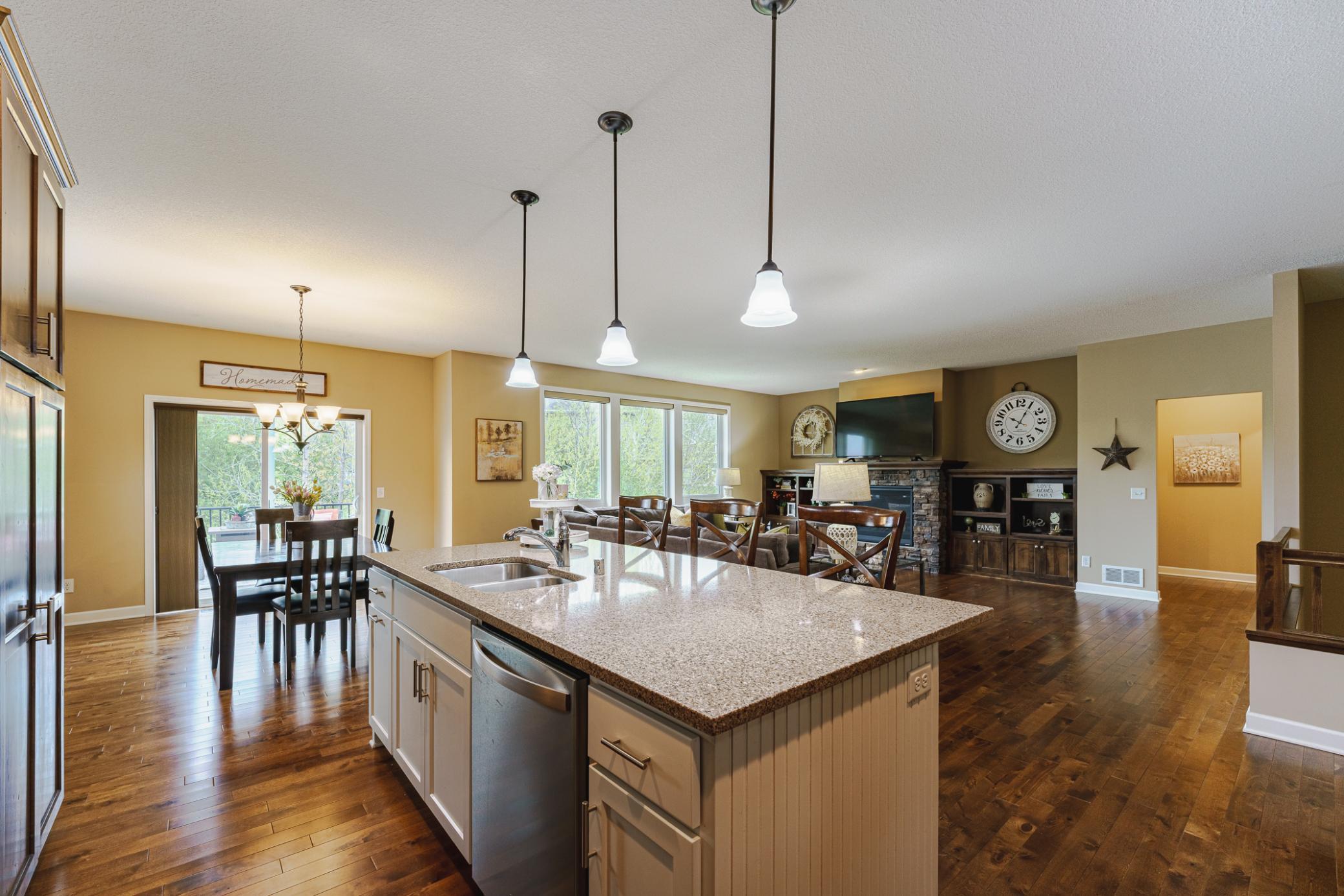 Three pendant lights hang over the island.