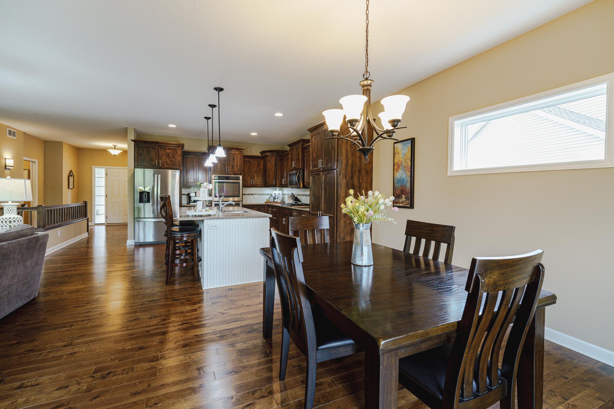 The informal dining space has birch hardwood floors and a bright transom window on the southwest wall.