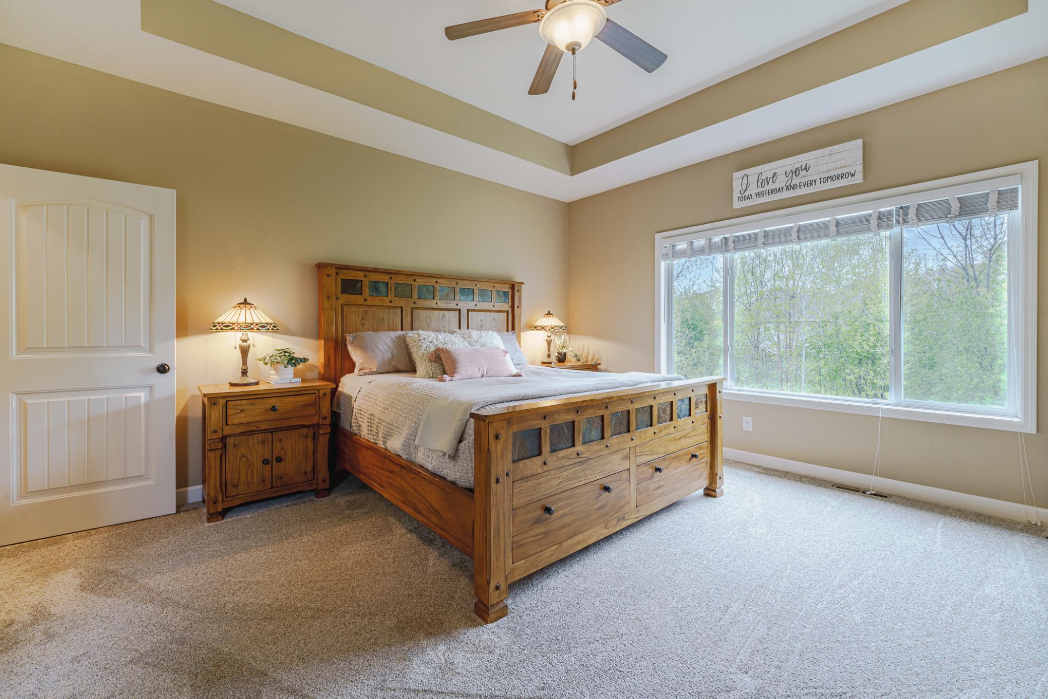 The owner’s suite is spacious with a tray-vaulted ceiling with a ceiling fan, and a FULL private bath. The bedroom overlooks the backyard via three large windows.