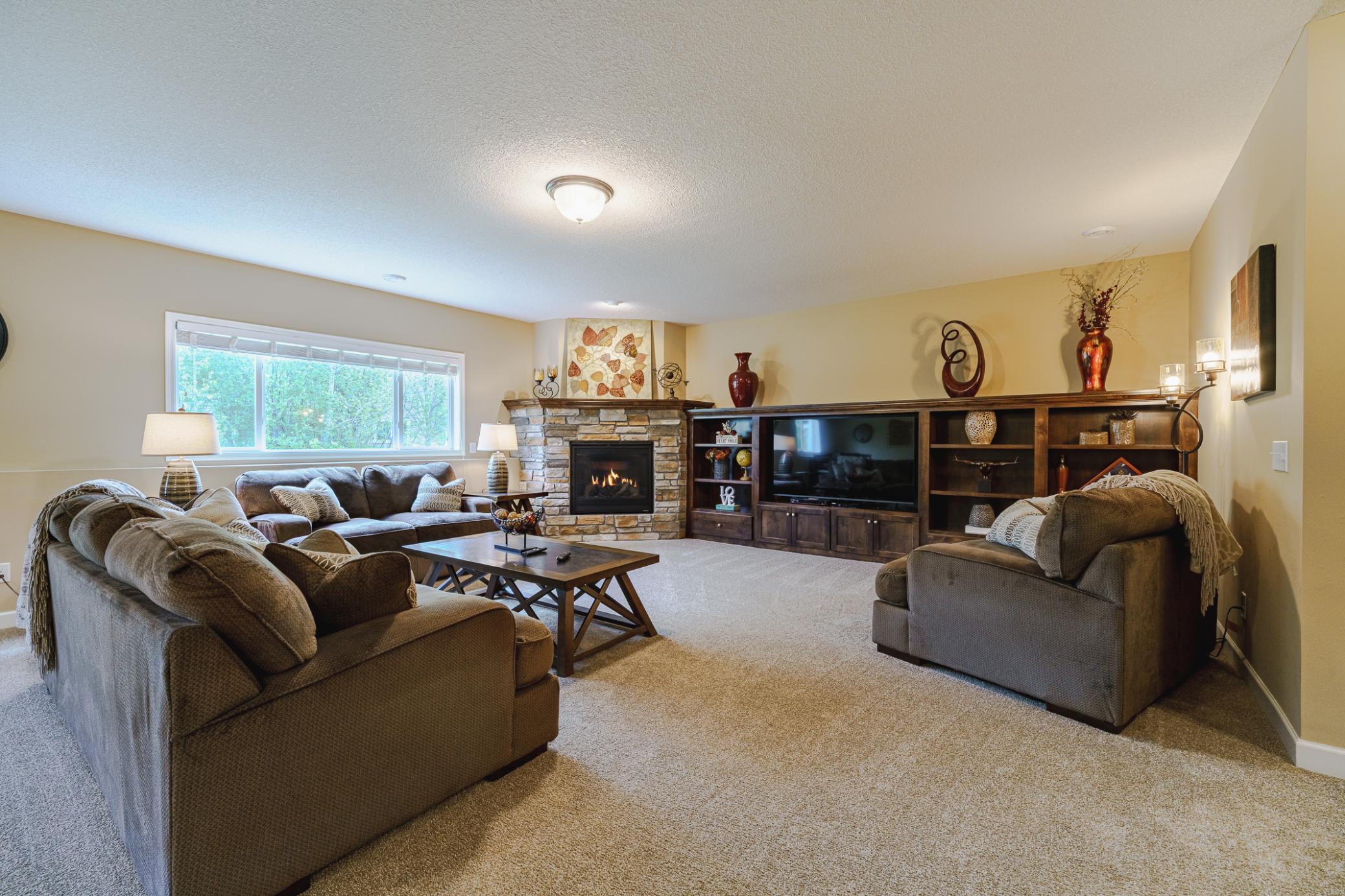 The lower level is inviting, with a warm, neutral color palette, daylight windows and 9-foot ceilings