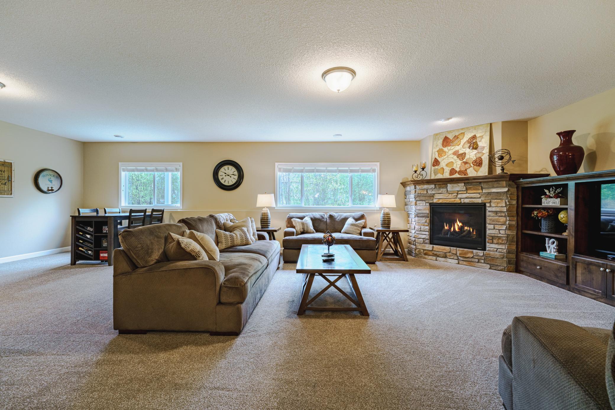 A stone fireplace and knotty alder built-ins are the focal feature as you come down the stairs into the lower level family room. This large room has a nice carpet/pad and can accommodate your furnishings plus your game table.