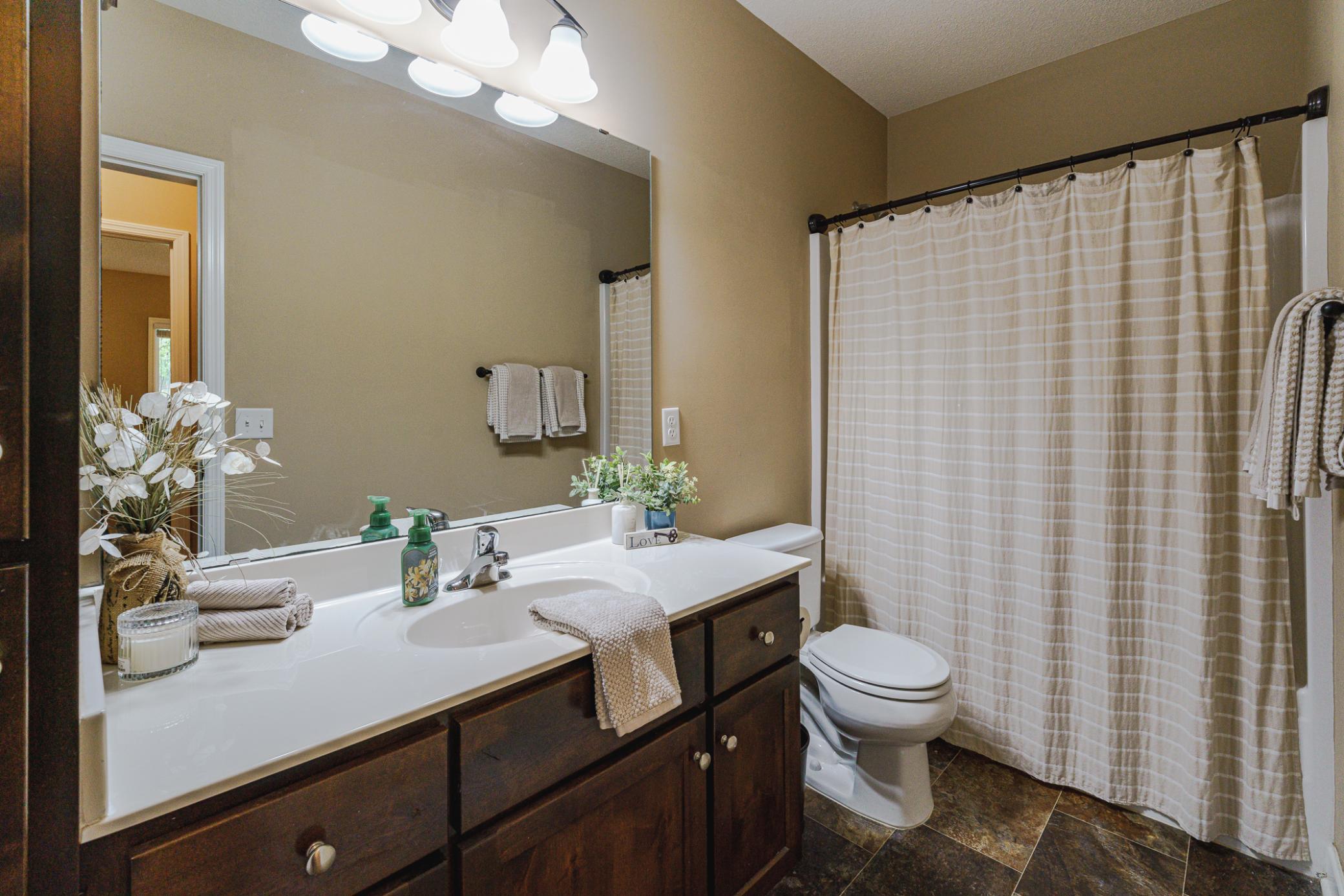 The lower level has a FULL bath with alder cabinets including a linen stack. There is additional linen storage in the hall.