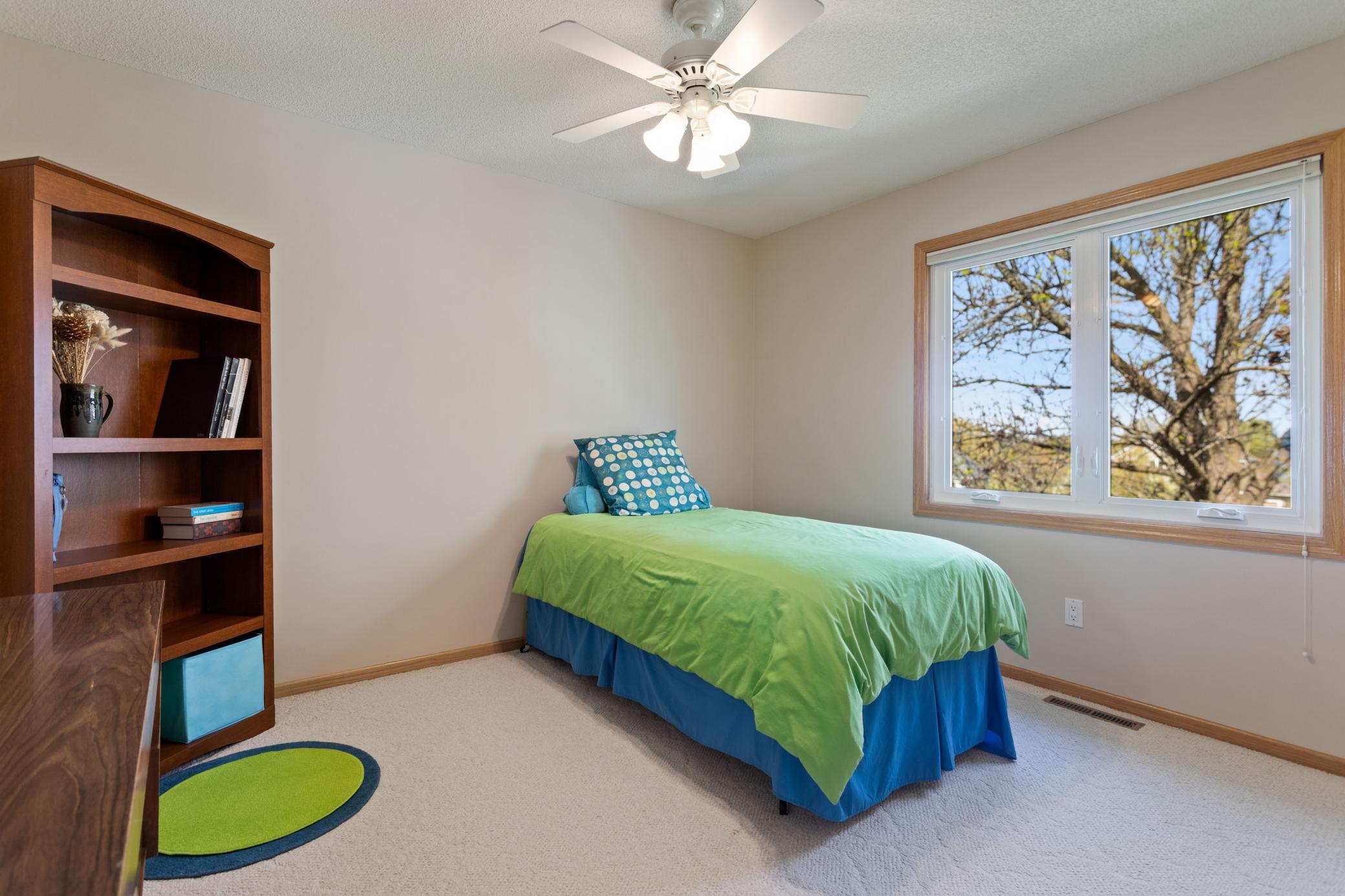 Main Level Bedroom #3 with ceiling fan and generous sized closet