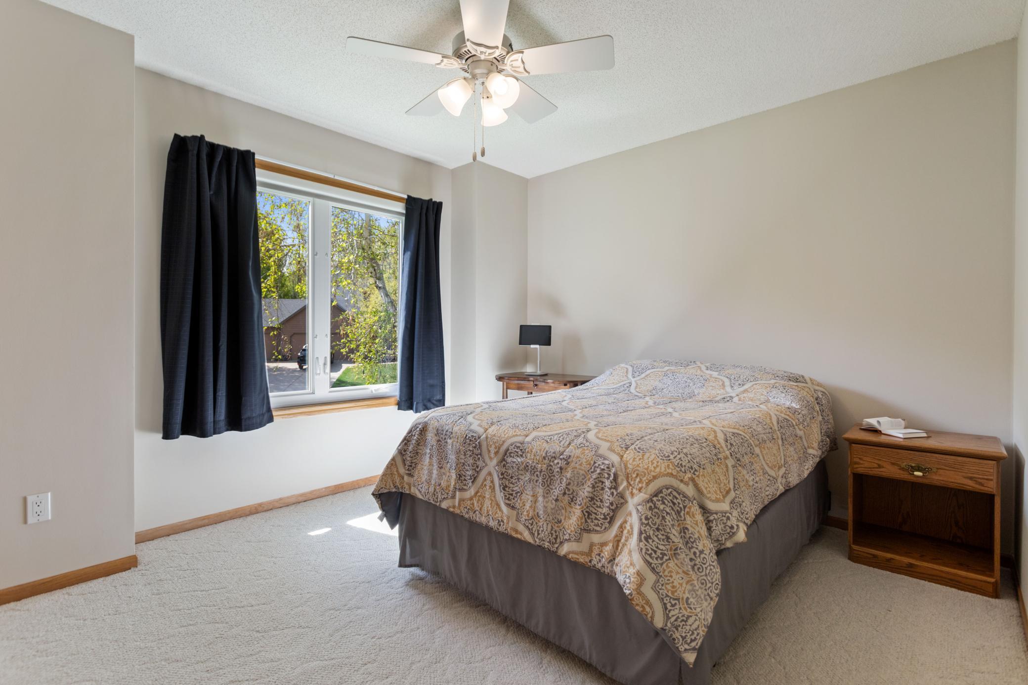 Main Level Bedroom #2 with ceiling fan and generous closet space