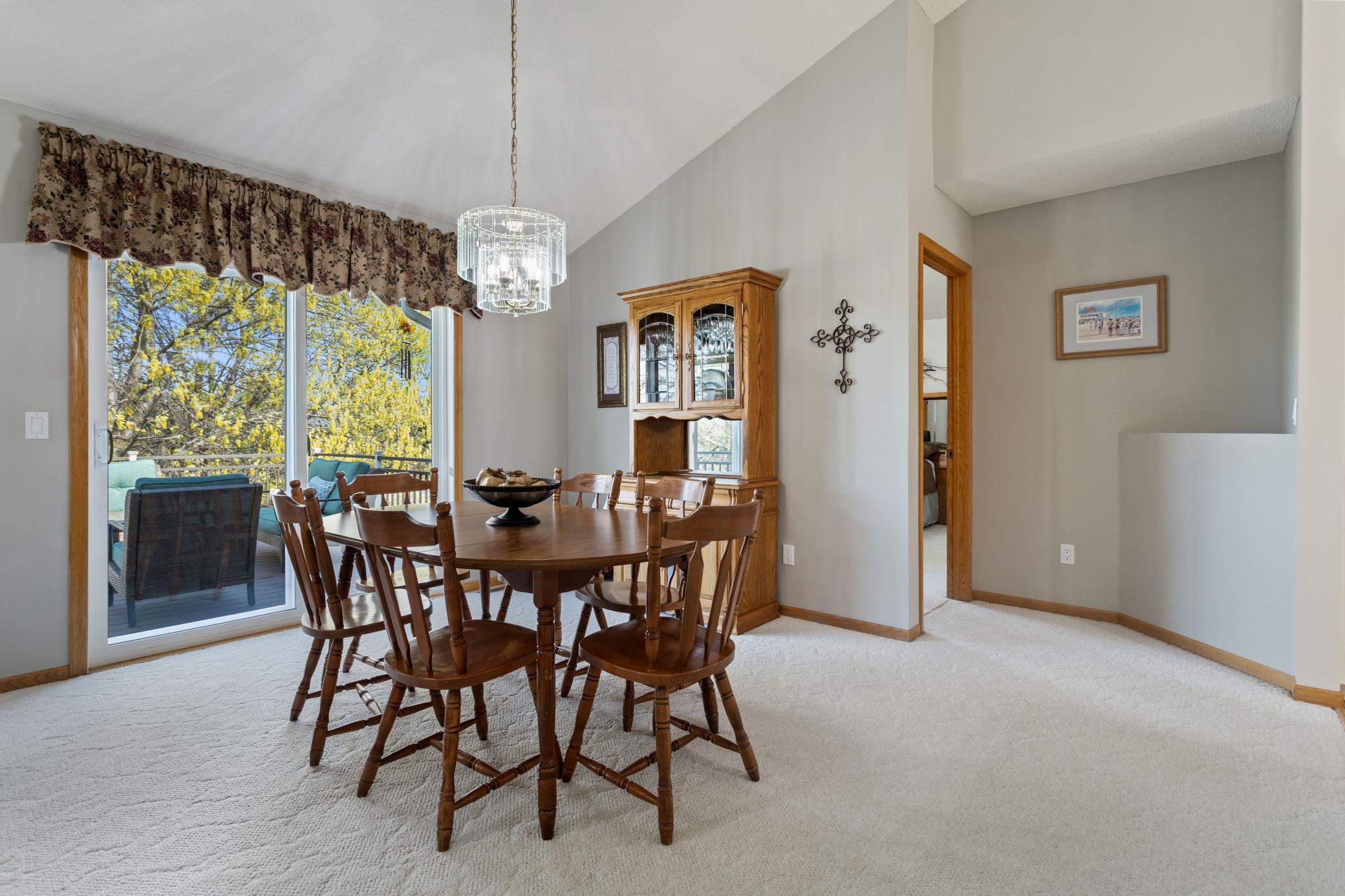 Formal Dining Room has vaulted ceiling and is just off the kitchen. Step out the patio door to the updated deck with staircase to ground level.