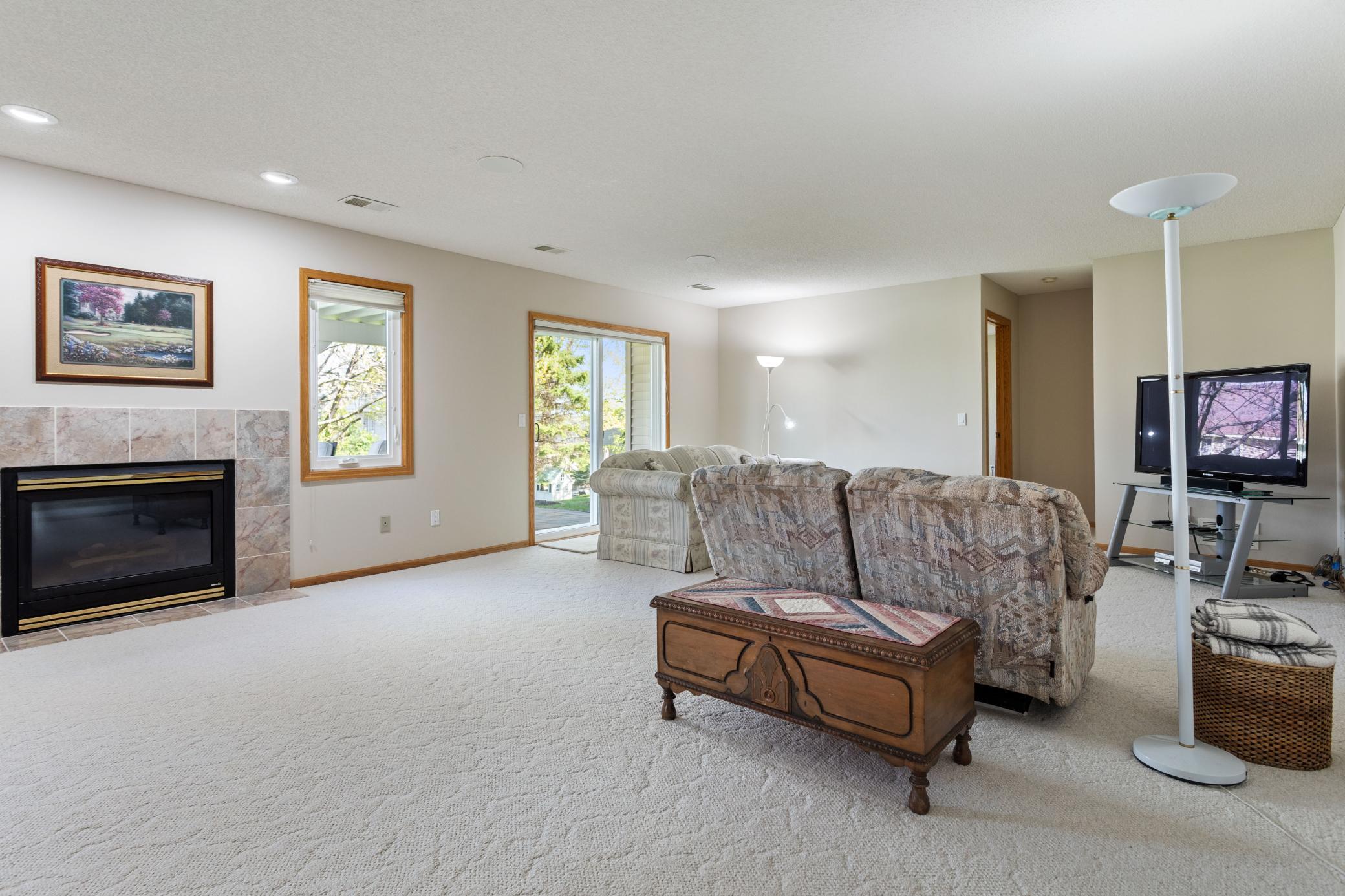 Lower level walk-out family room walks out to 25' X 12' paver patio and separates the two bedrooms. Has a gas fireplace with windows on each side and spacious enough for a game table or additional seating space