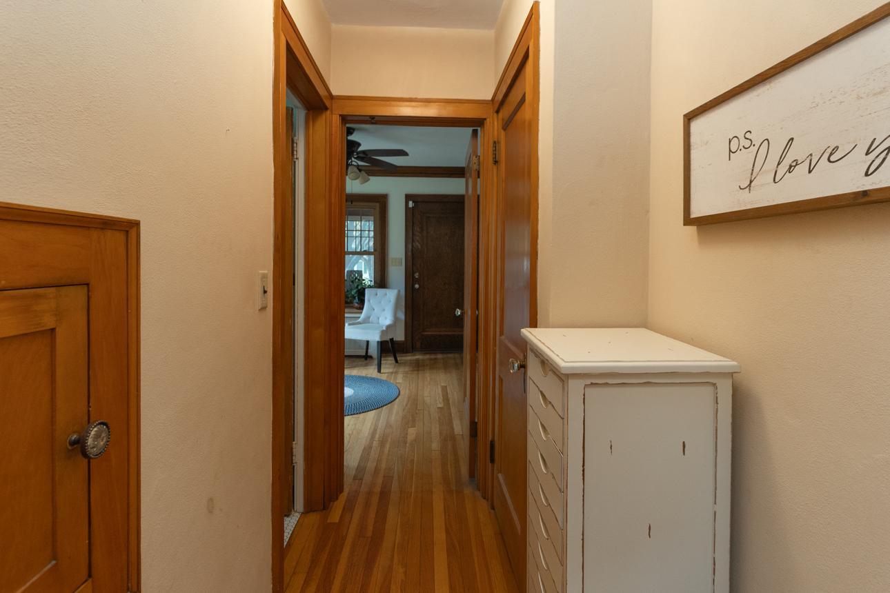 Hallway leads to the bathroom and living room, complete with a convenient laundry chute