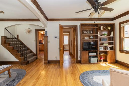 Exquisite character fills the main level with hardwood floors, detailed ceiling molding, built-in shelving, and an eye-catching staircase