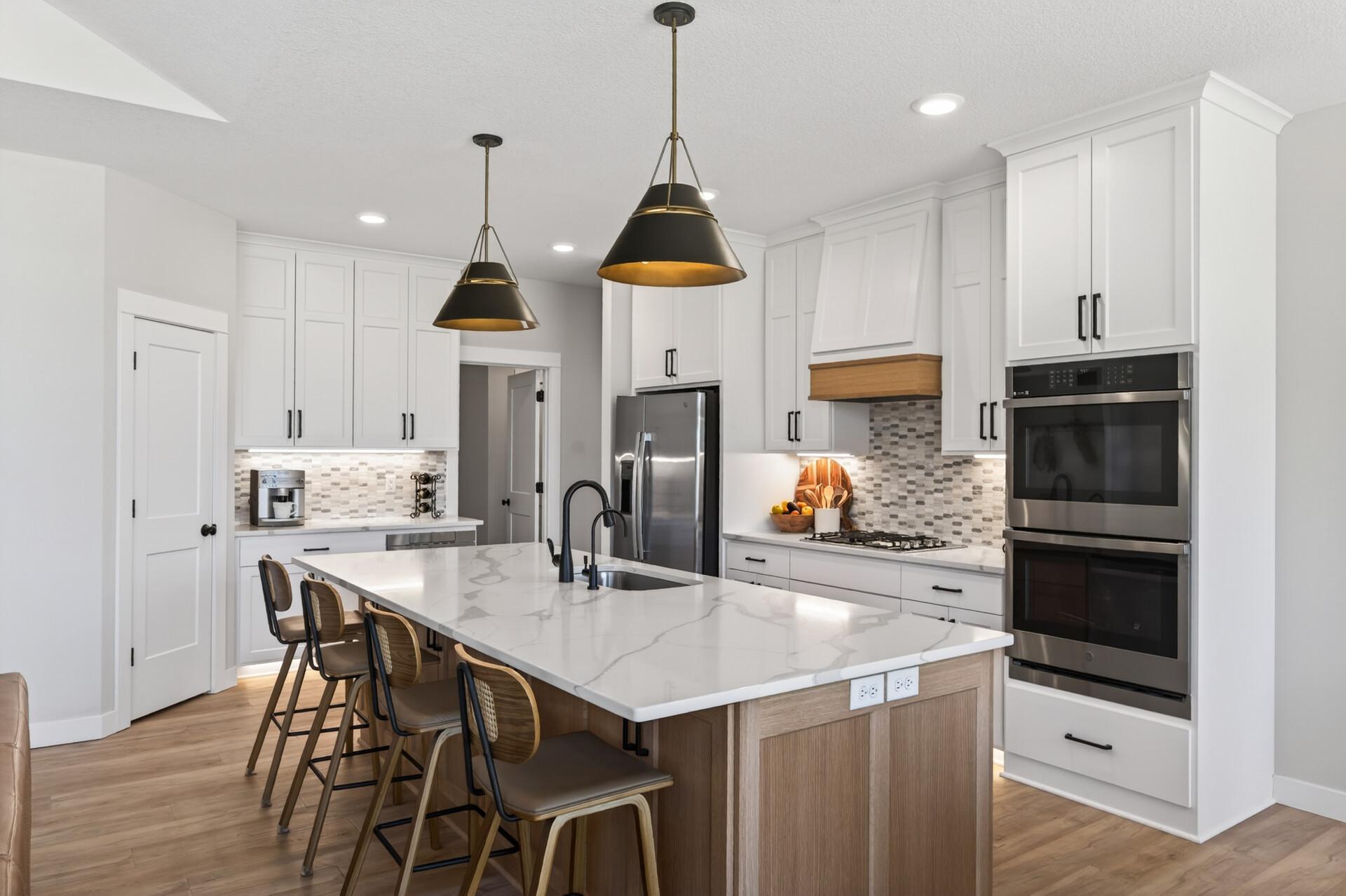 The kitchen is a true centerpiece with quartz countertops, walk-in pantry perfect for both everyday living and entertaining