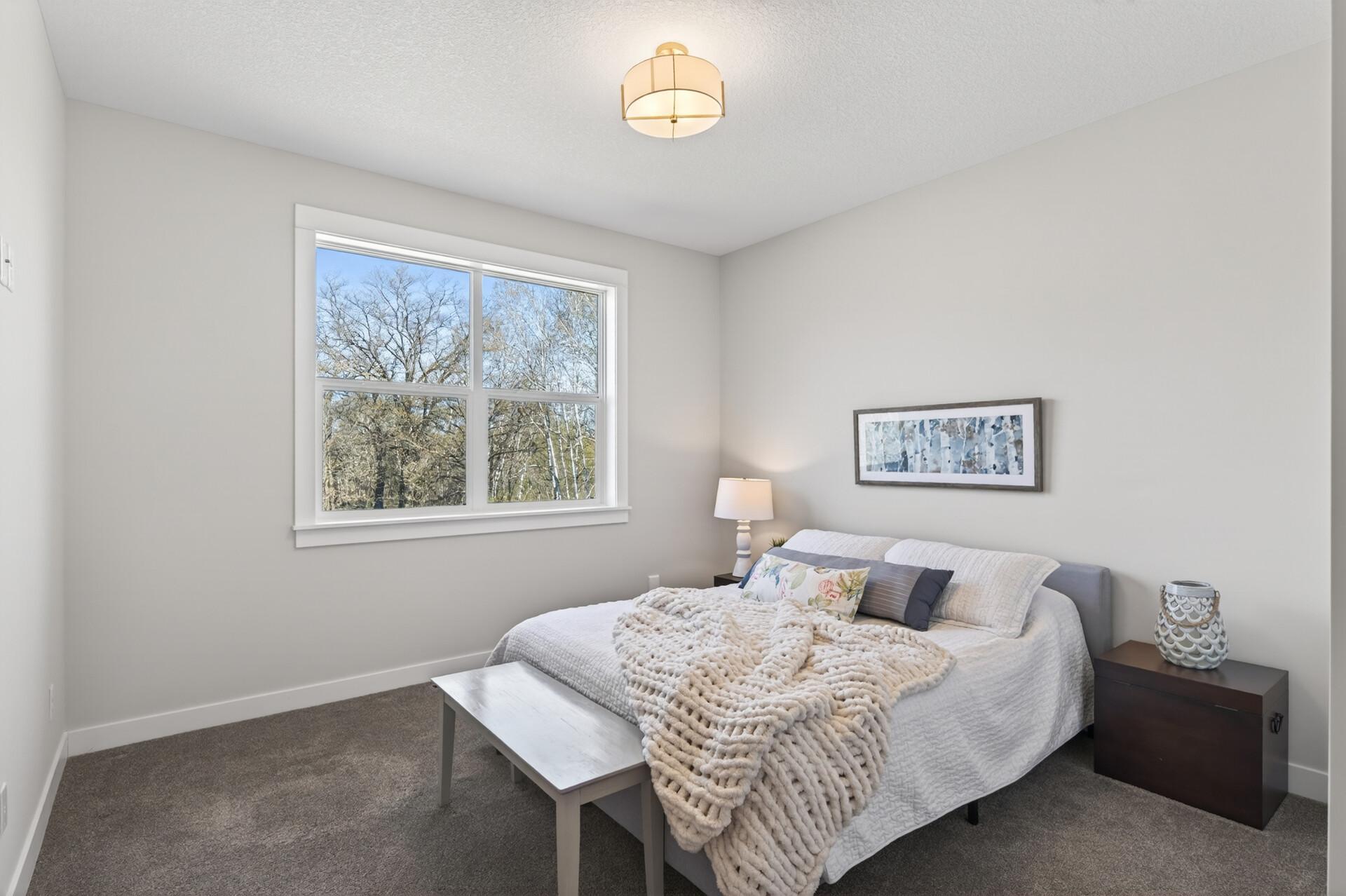 Two additional bedrooms and a full bath are located on the opposite side of the main level.