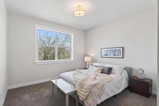 Two additional bedrooms and a full bath are located on the opposite side of the main level.