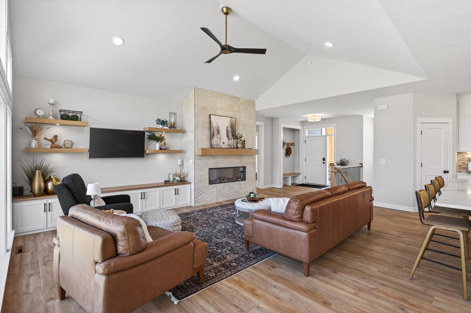 Stunning living room with an electric fireplace and tiled surround, flanked by custom built-in cabinetry