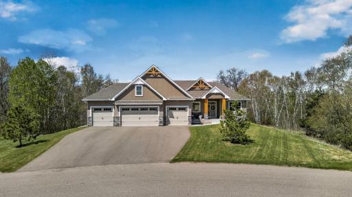 Beautifully designed 2023 rambler walkout sits on 4 private acres with serene wooded views