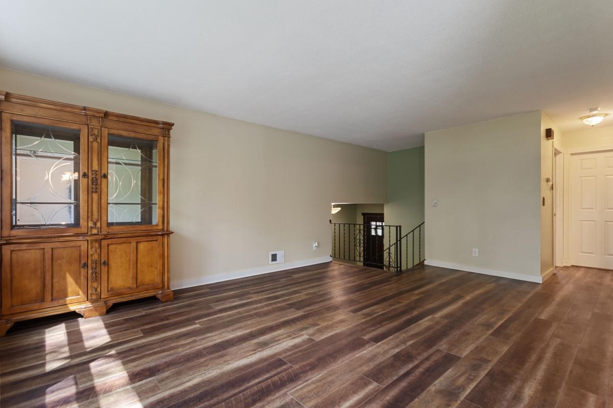 The welcoming foyer showcasing a beautiful Craftsman-style front door that sets a warm, timeless tone. A new service door provides convenient access to the garage.