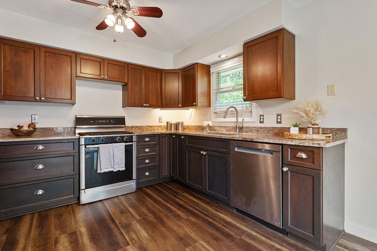 Newer cabinetry offers soft-close doors and drawers for a high-end feel, while granite countertops and undermount sink add both beauty and functionality.