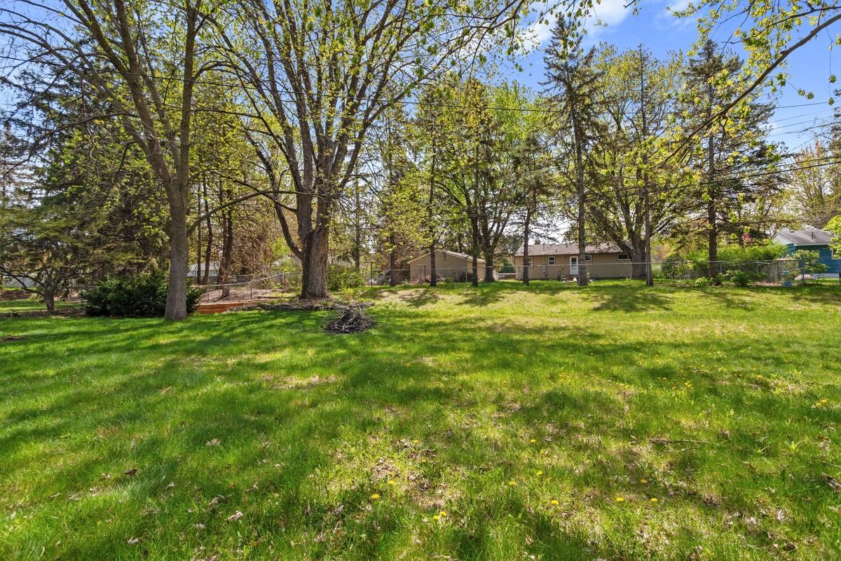 The large, fenced yard has plenty of space for kids, pets and gardening!