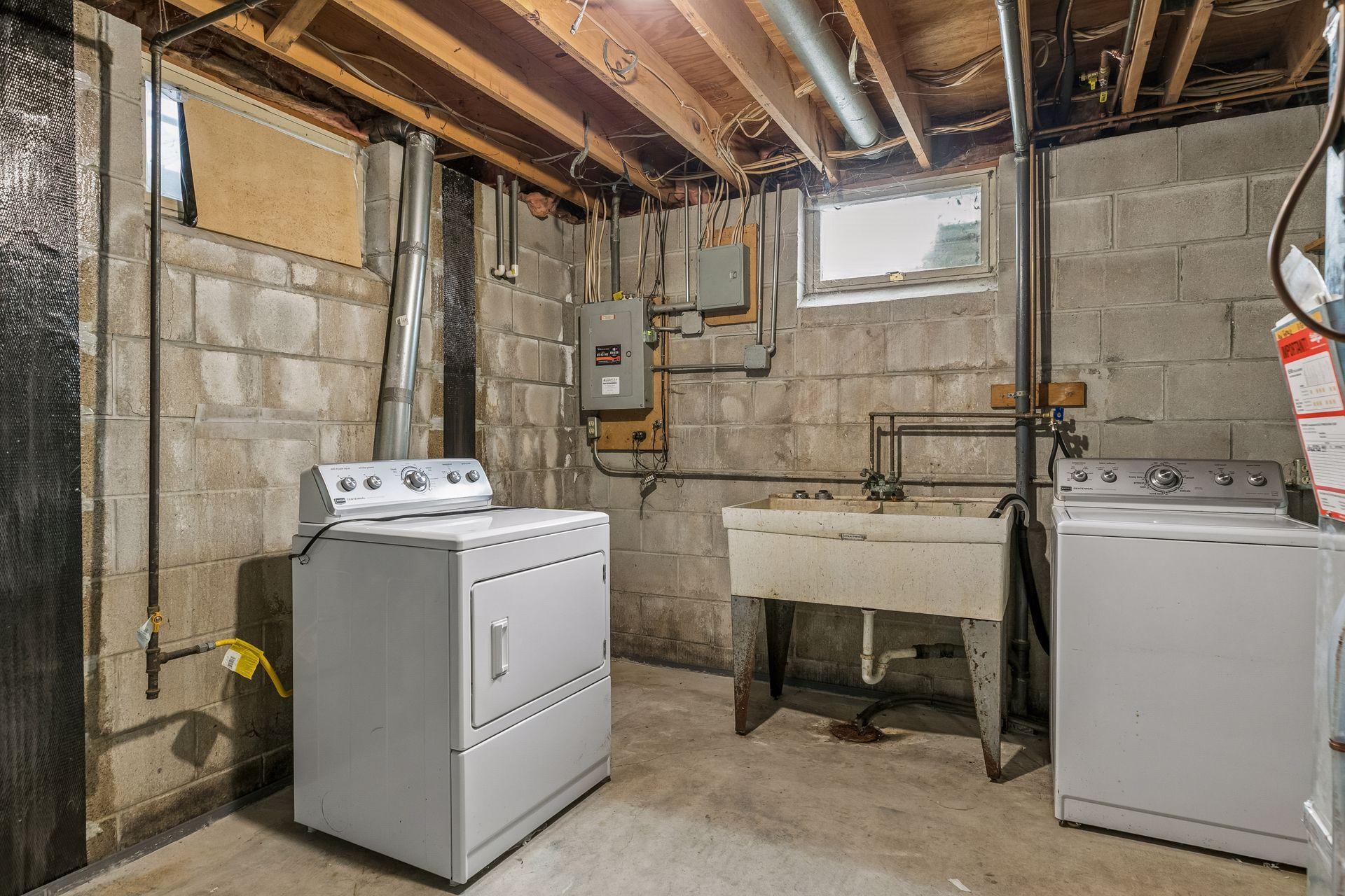 Utility room with washer and gas dryer, washtub. Excellent storage.