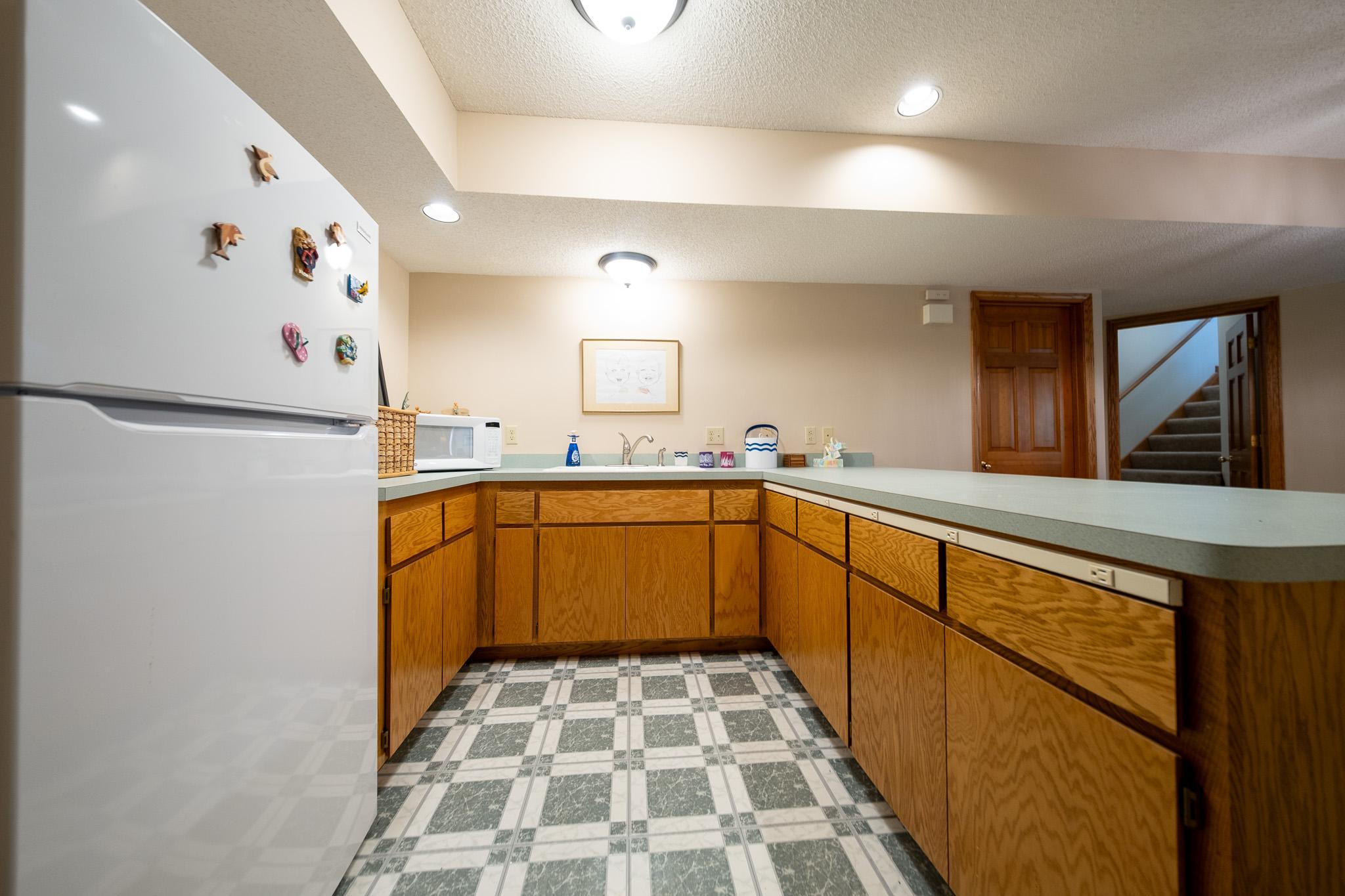 Lower bar equipped with full fridge and sink