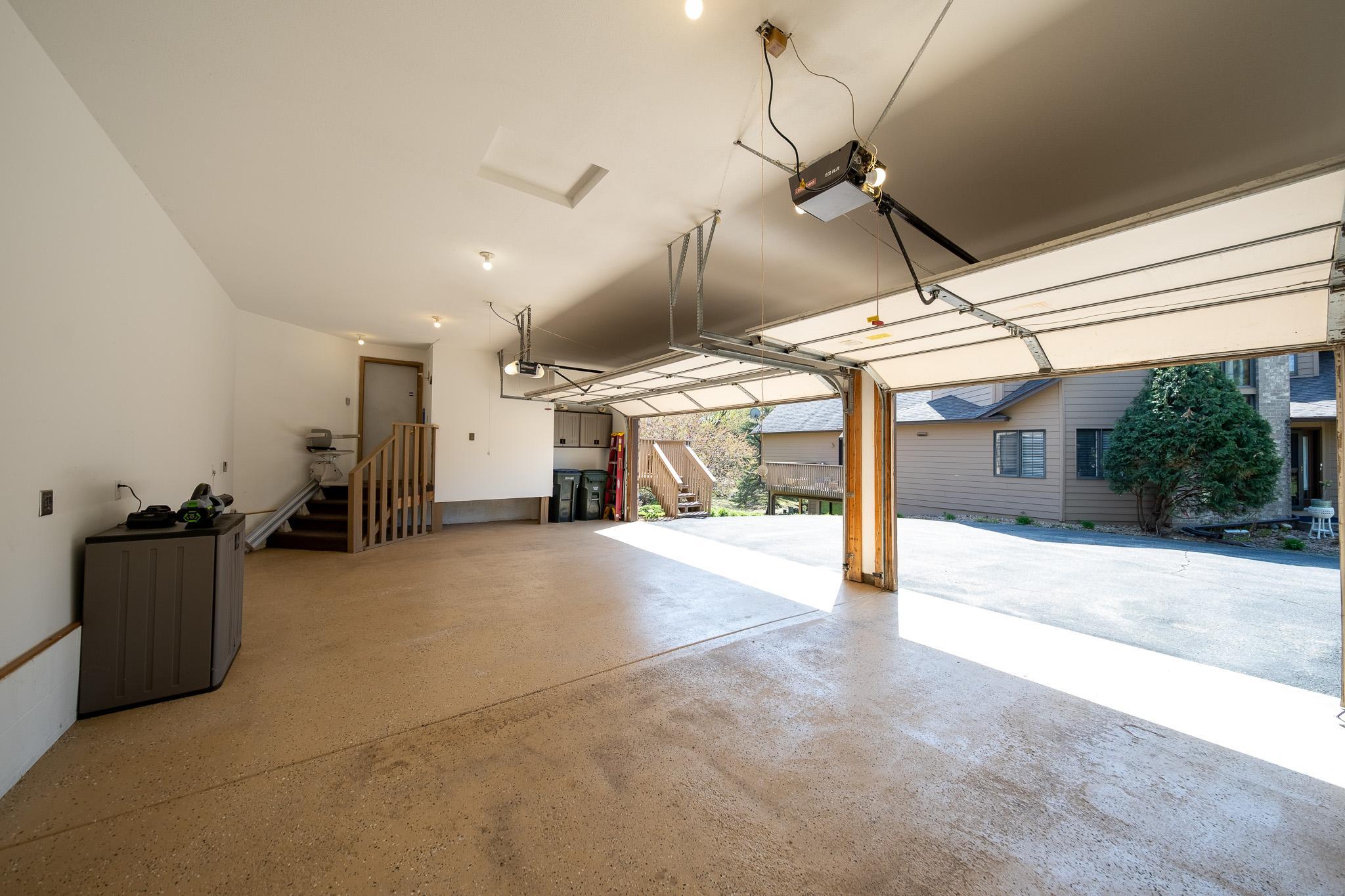 Three car garage with finished walls and flooring