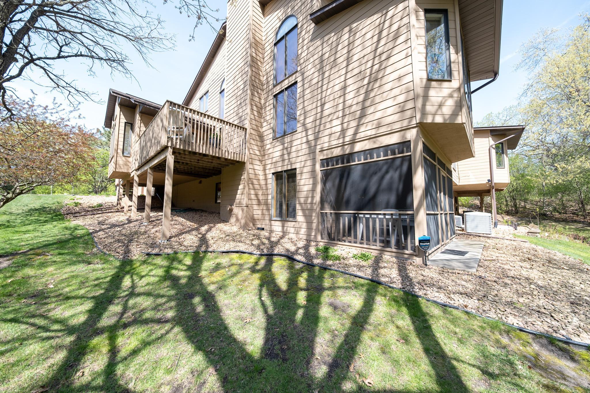 Views of the side of the home and the screened in porch