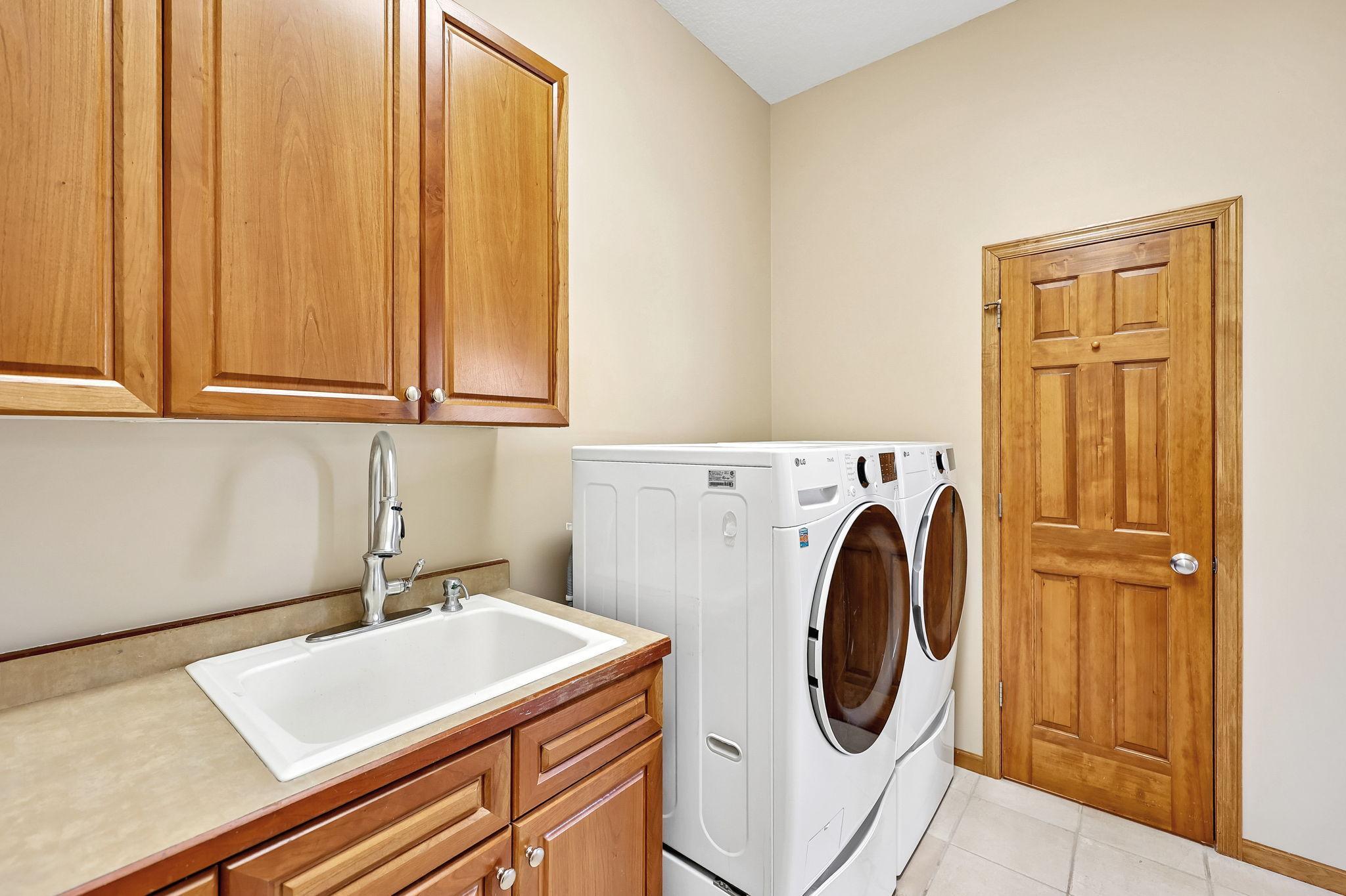 Convenient laundry with large mudroom closet for all the coats/boots/shoes