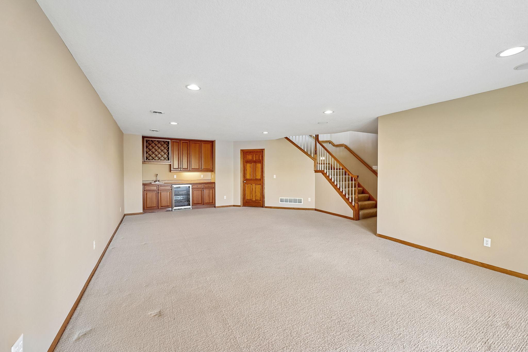 Lower level family room with wet bar/wine rack and mini fridge
