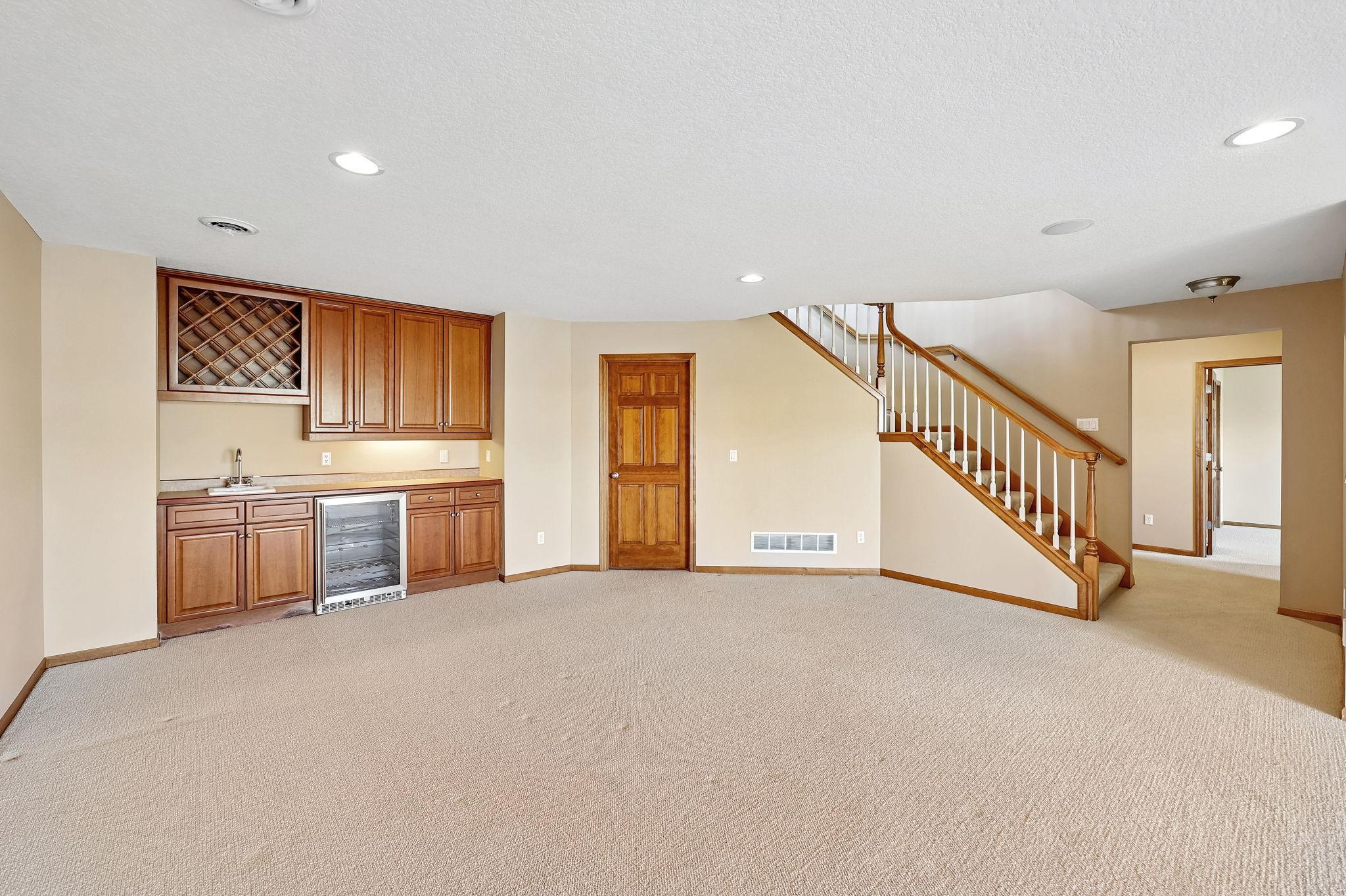 Lower level family room with wet bar/wine rack and mini fridge