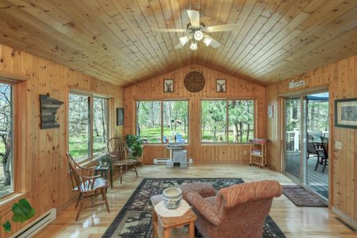 Large sunroom with hardwood floors and natural woodwork!!