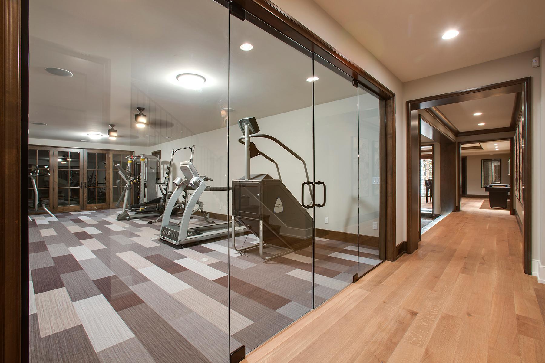 Frameless glass door wall adjacent to 3/4 bath, changing area and custom cedar steam sauna
