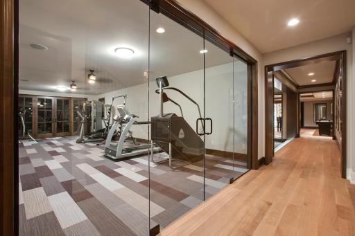 Frameless glass door wall adjacent to 3/4 bath, changing area and custom cedar steam sauna