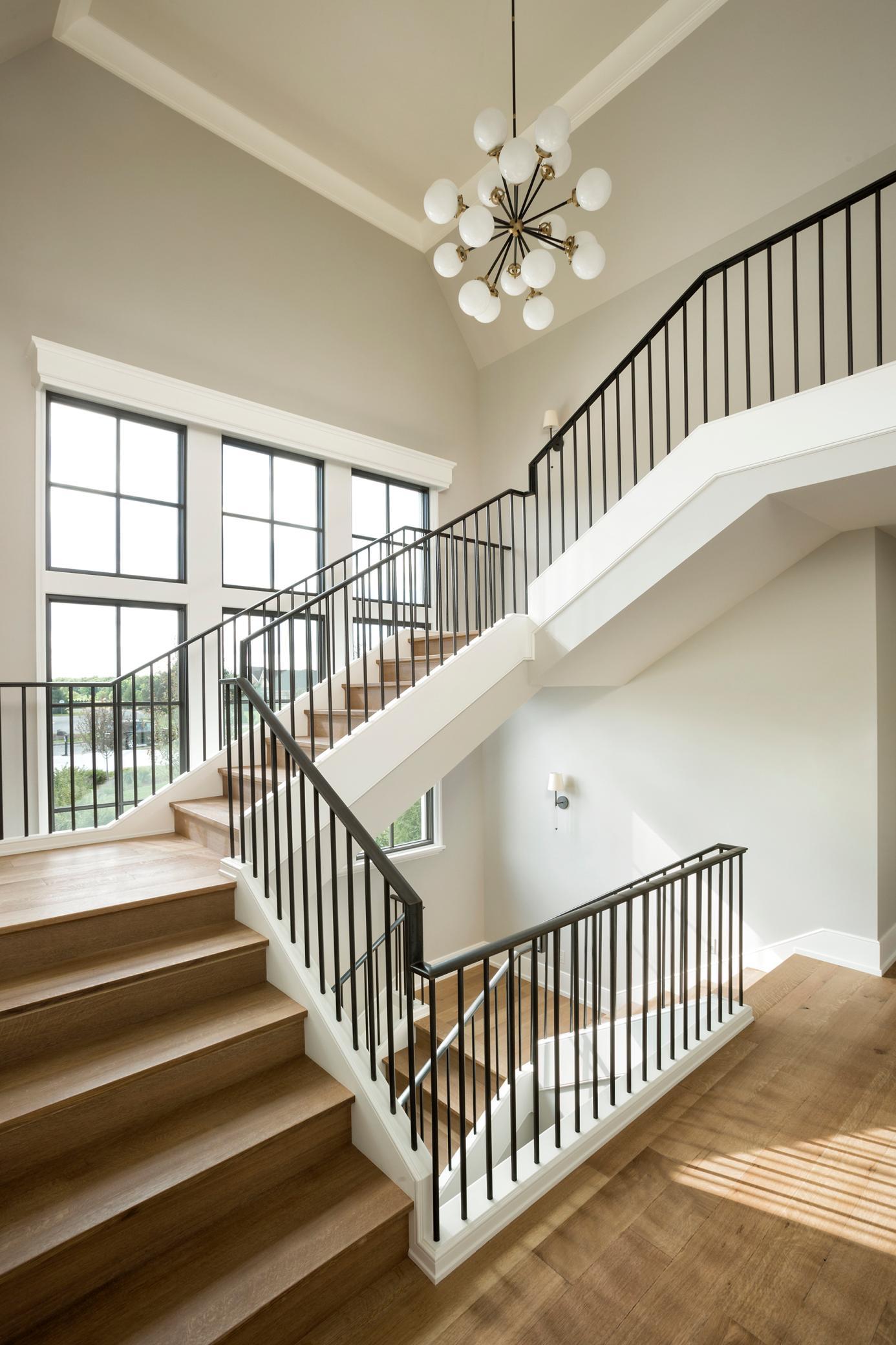Custom iron rails built on site with custom white oak treads and wood risers