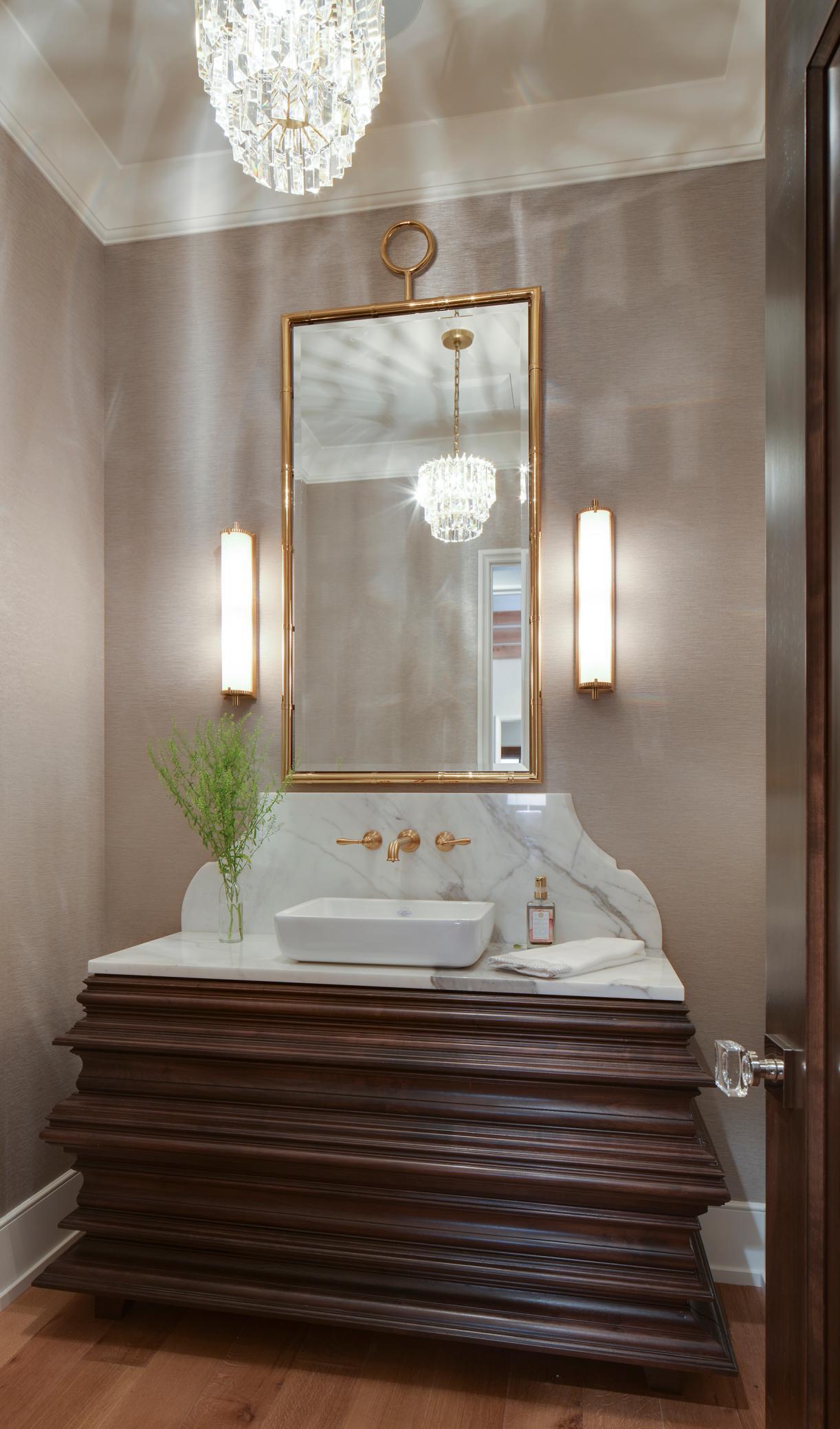 One of 7 bathrooms, this main-level powder room features a handcrafted walnut vanity with a vessel sink