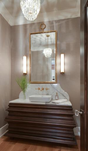 One of 7 bathrooms, this main-level powder room features a handcrafted walnut vanity with a vessel sink