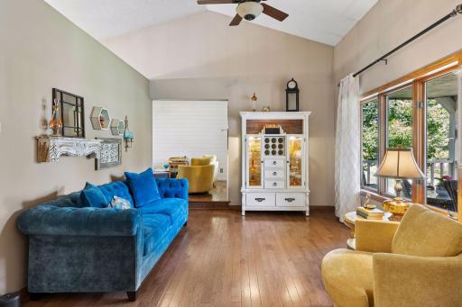 Formal living room with hardwood floors and vaulted ceiling.