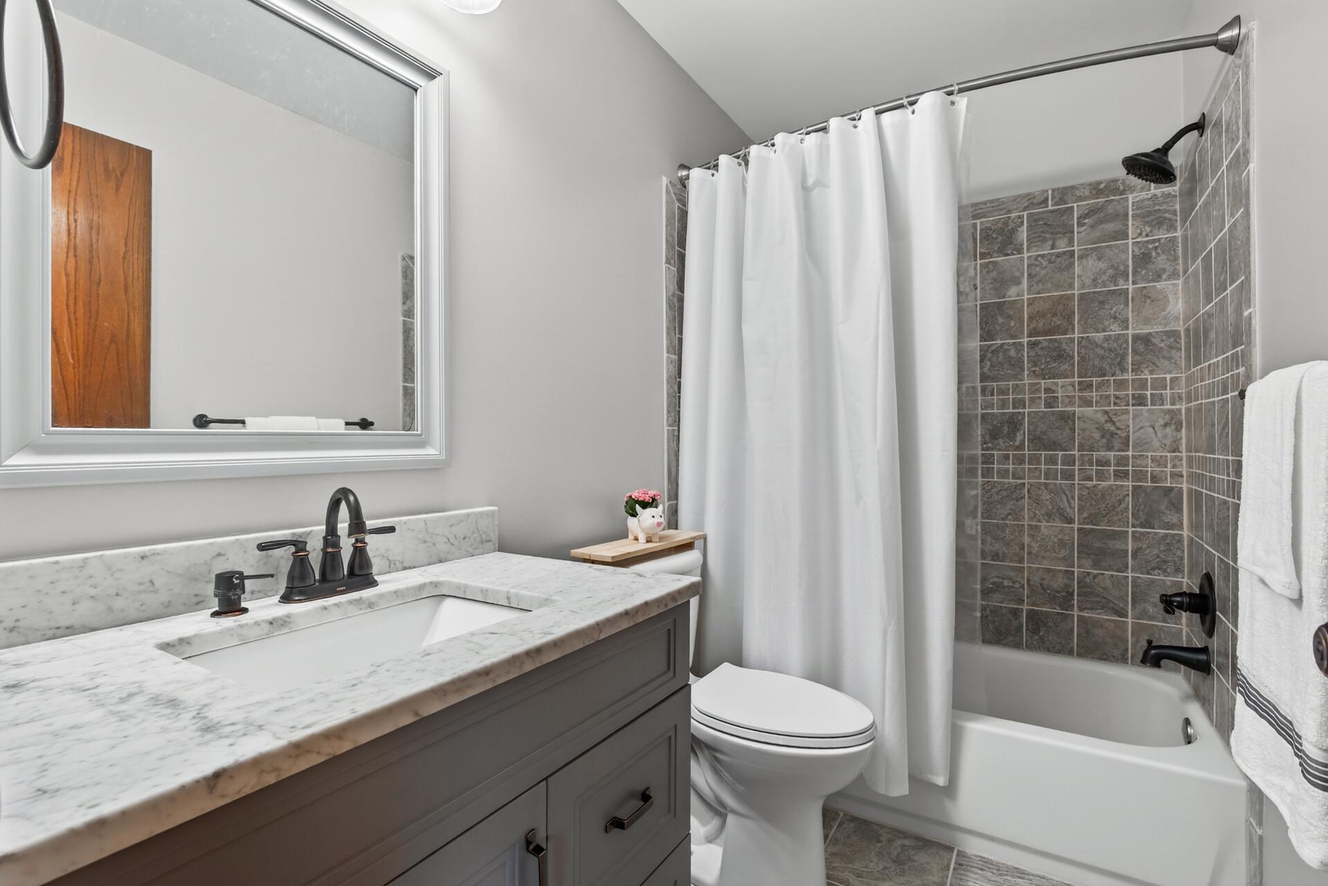 Beautifully updated full bathroom upstairs with tile surround