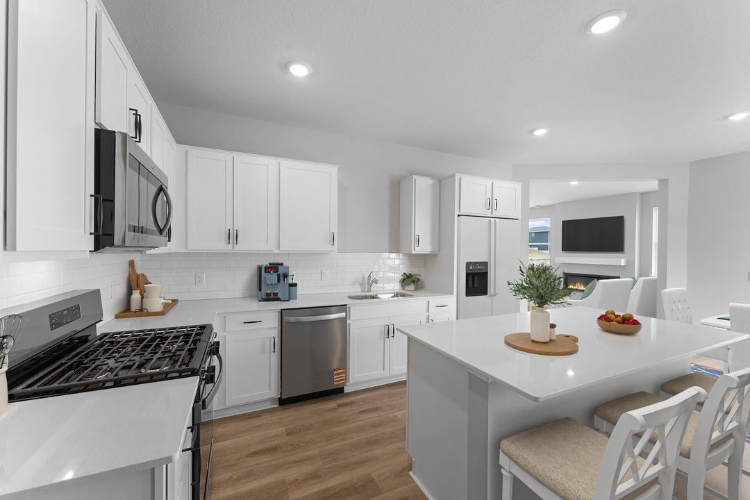 Spacious kitchen with large island make this a great space to gather while meals are prepped. *Picture is of an inventory home; actual finishes may vary.