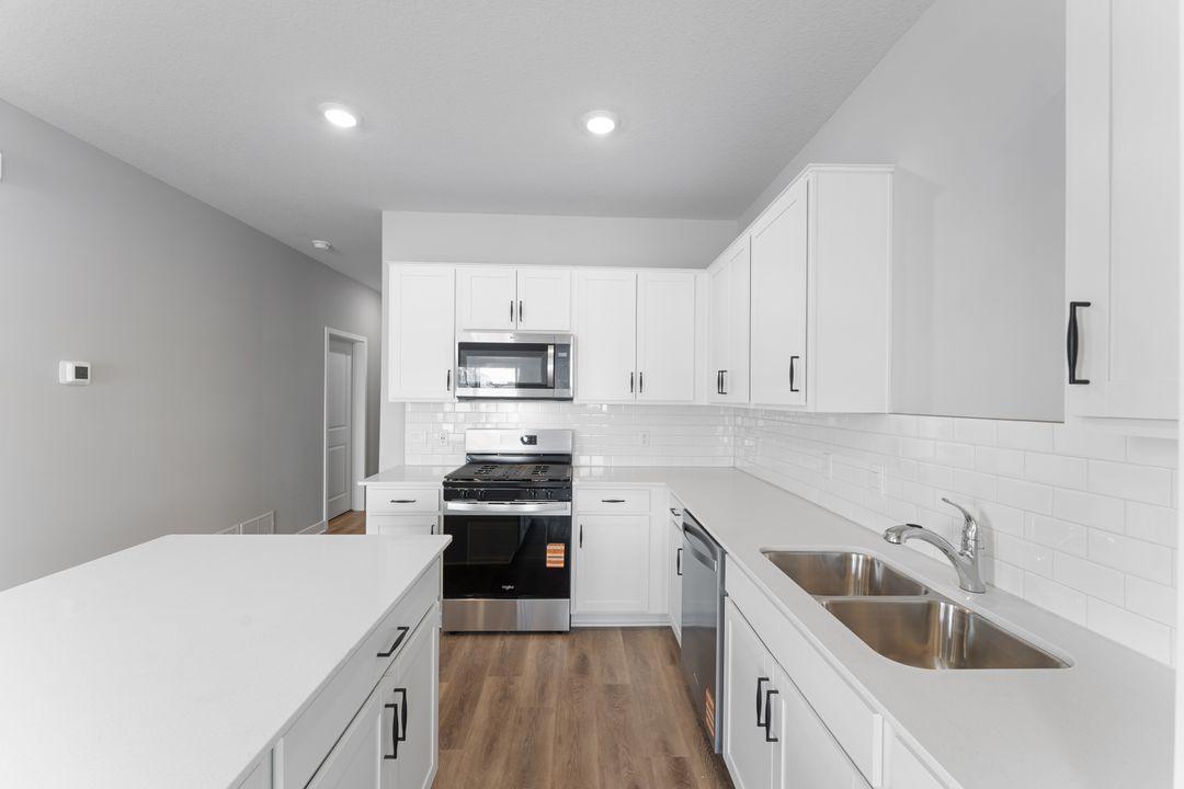 Highlighted with stainless steel appliances, quartz countertops and subway tile backsplash, this kitchen is showstopper. *Picture is of an inventory home; actual finishes may vary.