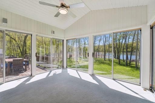 Three Season Porch with adjoining deck and stairs to the yard and lake