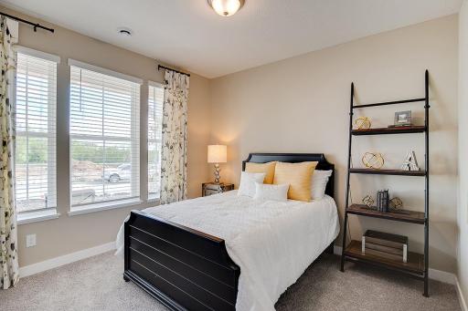 Located at the front of the home, this is the first of two secondary bedrooms/flex rooms. Lovely windows and plenty of space. Photo of model, colors and finishes will vary.