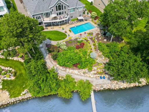Manicured grounds seamlessly connect the pool to the lakefront.
