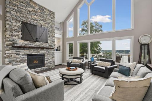 This exceptional home is filled with natural light, dramatic vaults, stunning lake views, stone fireplace.