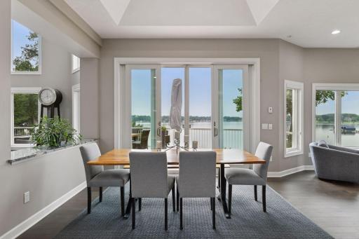 Informal dining area featuring tall French doors walks out to large deck, great for indoor/outdoor entertainment.