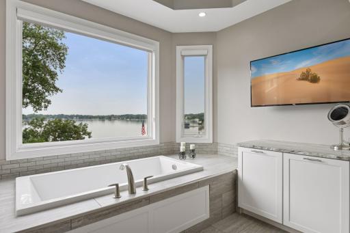 Relax and enjoy this soaker tub with a lake view
