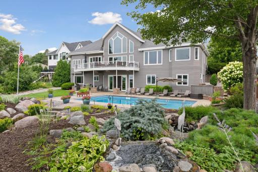 Enjoy long summer days by the updated 20' x 40' saltwater pool and waterfall overlooking the lake