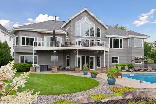 This property has it all - active lake community/neighborhood, 128 ft. lakeshore, saltwater pool, garages for 6 cars, main floor primary suite and office, geothermal heating and cooling and more!