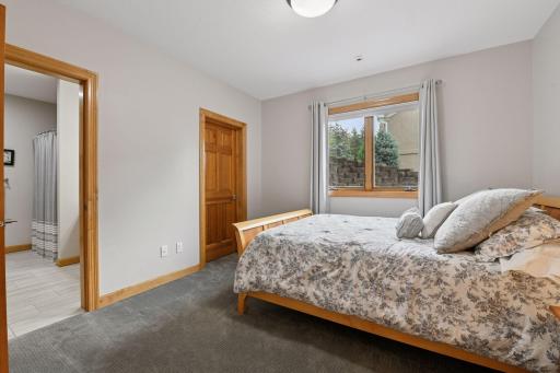 One of three bedrooms located in the lower level - walks through to the full bathroom and features a large walk-in closet.