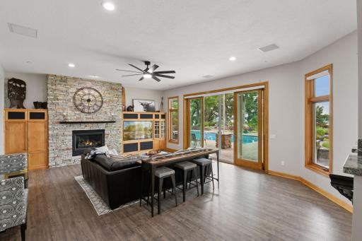 Entertainment-ready walkout lower level with fireplace & sliding doors to the pool.