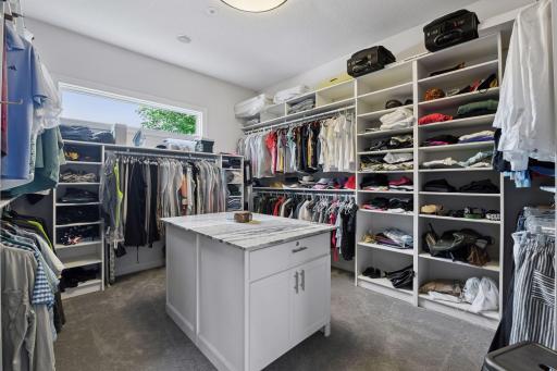 The closet of your dreams! New island cabinetry with locked drawers and granite countertop.