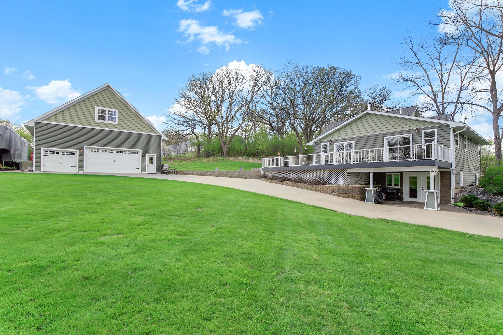 Updated home with a spacious wraparound deck plus a finished, heated 3-car garage with bonus living space above.
